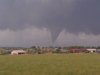 A Thursday, June 7, 2022 photo provided by Andrew Kniss shows a funnel cloud, seen from Kniss's car on Highway 34, near Wheatland, Wyoming. The rare quarter-mile-wide tornado cut a swath across mainly open country in southeastern Wyoming, damaging homes, derailing empty train cars and leaving one person with minor injuries, officials said. The twister was part of a powerful storm system that rolled through parts of Colorado and Wyoming Thursday afternoon and evening, packing heavy rains, high winds and hail. (AP Photo/Andrew Kniss)