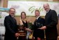 Gerry Ritz and Pat Bell pose with Lisa and David Taylor, winners of the 2008 BC Outstanding Young Farmers award
